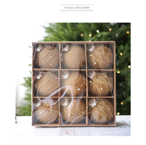 Detail of 9-piece champagne brown flocked Christmas balls with gold sequins in a gift box