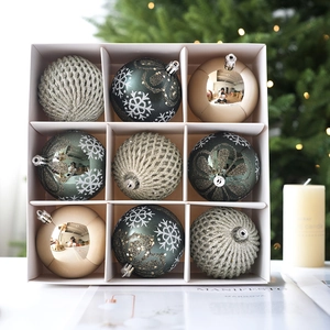 9-piece set of emerald green and champagne gold Christmas tree ornaments in a gift box