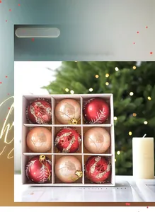 Detail of red and champagne gold Christmas balls with glitter swirls and painted patterns