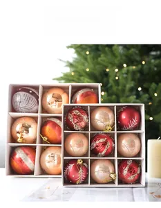 Detailed view of red and gold Christmas ball ornaments with festive glitter patterns
