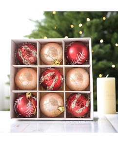 Detail of 9-piece red and champagne Christmas ball ornaments set with glitter and patterns