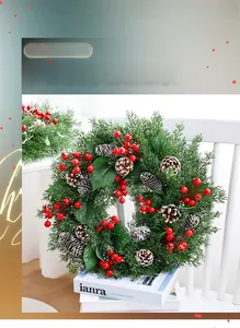 Detail of Christmas wreath with pine needles, red berries, and cones on a white chair