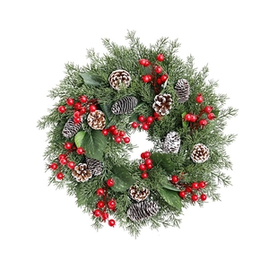 Christmas candle ring wreath with pine needles red berries and frosted pinecones decor