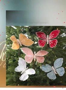 Detail of sequined butterfly ornaments with pearls on a lit Christmas tree