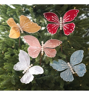 Detailed view of colorful fabric butterflies with pearls on a lit Christmas tree