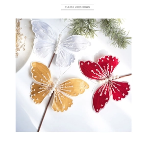 Close-up of decorative Christmas butterfly picks with sequins and pearls in multiple colors