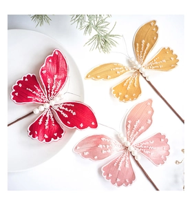Detail of glitter fabric butterfly ornaments with pearl bodies and wired stems