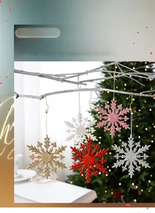 Close-up of colorful glitter Christmas snowflake ornaments with gold hanging hooks