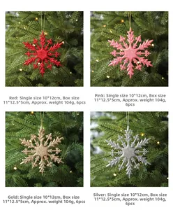 Glittery 10cm Christmas snowflake ornaments in four colors shown on a decorated tree