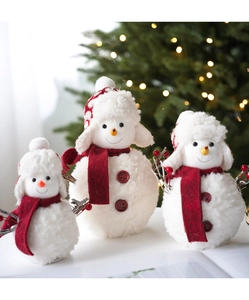 Three plush snowman decorations with red scarves and hats on a festive background