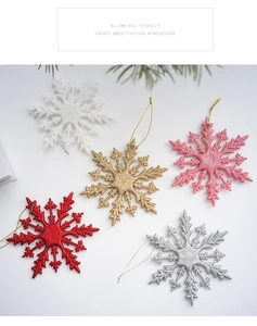 Close-up of glittery snowflake ornaments in 5 colors with matching hanging strings