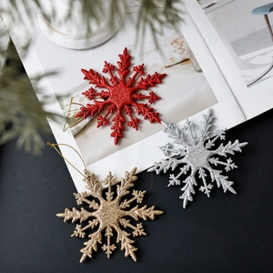 Glittery 10cm Christmas snowflake ornaments in red, gold, and silver with hanging strings