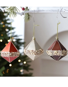 Detail of luxury Christmas ball set with pearls and sequins on white branches