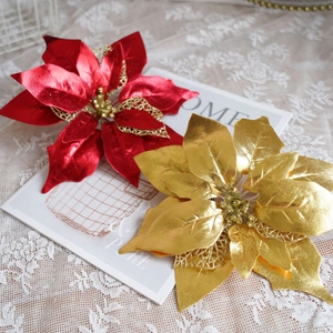 Artificial red and gold Christmas poinsettia flowers with glitter hollow design details