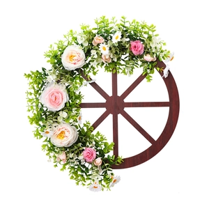 Rustic wooden wagon wheel wreath with pink roses and eucalyptus leaves for home decor