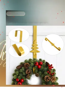 Detail of matte gold metal door hook featuring Christmas tree design and U-shaped bracket