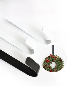 Detail of black and white metal door hooks for wreaths with a functional usage inset