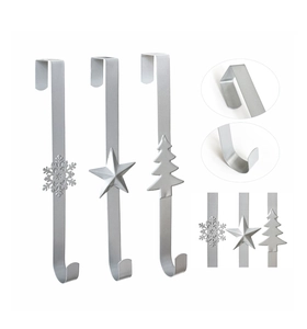Detail view of silver metal over-the-door hooks with snowflake, star, and tree designs
