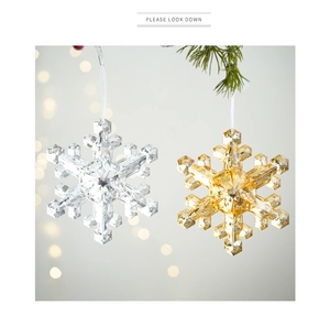 Detail of crystal and gold snowflake ornaments with multifaceted light refraction