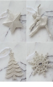 Macro detail of glittery silver Christmas star, angel, tree and snowflake ornaments