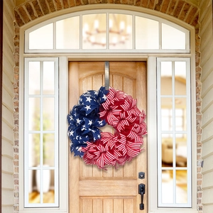 Close-up of patriotic USA flag wreath hanging on a front door for Independence Day decor