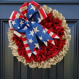 Macro shot of tiered red and burlap wreath with patriotic star-and-stripe patterned bow