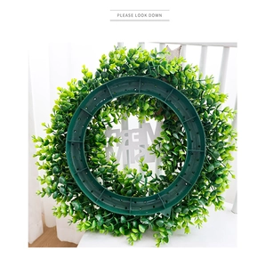 Detail view of the durable plastic back frame with white Merry Christmas text on eucalyptus wreath