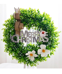 Detail of eucalyptus Christmas wreath with Merry Christmas sign and white daisy decor