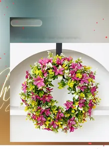 Detail of colorful artificial daisy wreath with magenta and yellow flowers on a front door