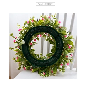 Detail showing the sturdy green plastic base and weaving craft of the floral wreath