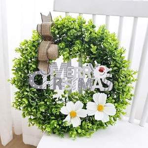Faux eucalyptus wreath with silver Merry Christmas sign and white daisies on chair