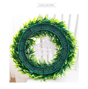 Rear view detail showing the sturdy plastic base and branch structure of the festive wreath
