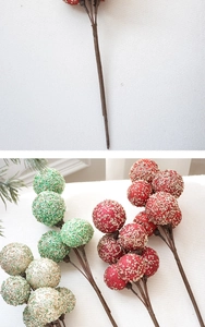 Detail of glittering Christmas artificial berries in red, green and champagne for holiday decor