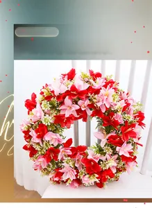 Spring garland with red and pink faux daisies on a white wooden chair background