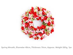 Detail view of 40cm spring wreath with pink lilies and green leaves on white background