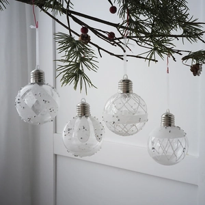 Set of 4 bulb-shaped Christmas ball ornaments with silver sequins on pine tree branches