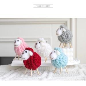 Close-up of handmade wool felt sheep ornaments in five colors for Christmas home decor