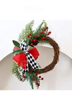 Close-up of Christmas wreath with rattan, pine cones, red berries and checkered bow