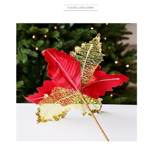 Detail of red and gold glitter Christmas flower with a stem on a warm holiday background