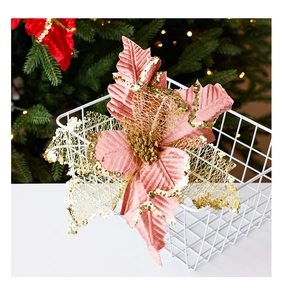 Close-up of pink and gold glitter artificial Christmas flower in a decorative basket