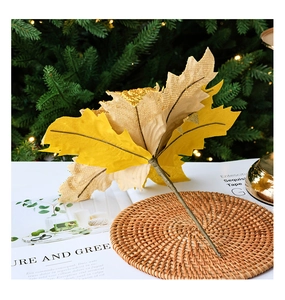 Detail of faux maple leaf branch with sparkling glitter texture for festive home decor
