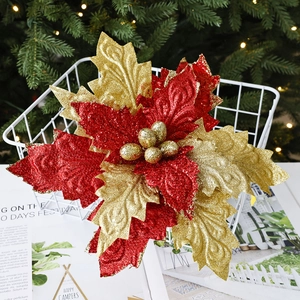 Sparkling red and gold velvet poinsettia Christmas flower in a white decorative basket