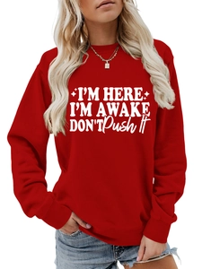 Close-up of the ribbed crewneck and white printed lettering on the red sweatshirt