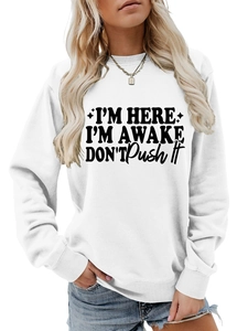 Detail of white cotton sweatshirt with bold I'm Here I'm Awake text and ribbed cuffs