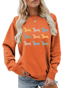 Detail of orange sweatshirt featuring a nine-grid colorful dachshund dog graphic print