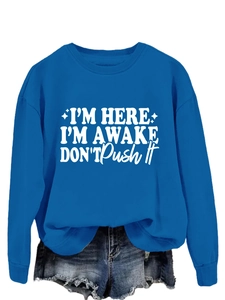Detail of royal blue crewneck sweatshirt with I'm Here I'm Awake white text design