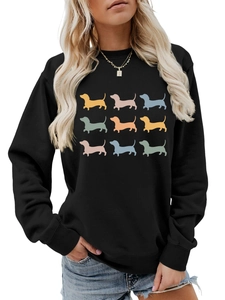 Close-up of nine colorful dachshund silhouettes printed on a black crewneck sweatshirt