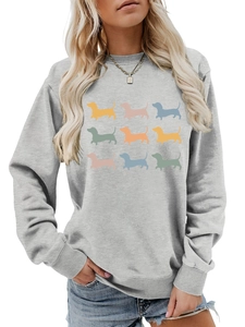 Detail of nine colorful dachshund silhouettes printed on a grey crewneck sweatshirt