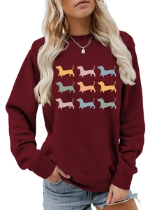 Detail of burgundy sweatshirt featuring nine colorful dachshunds in minimalist 3x3 print