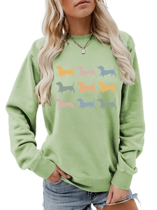 Detail of light green sweatshirt featuring a colorful 3x3 grid of dachshund silhouettes